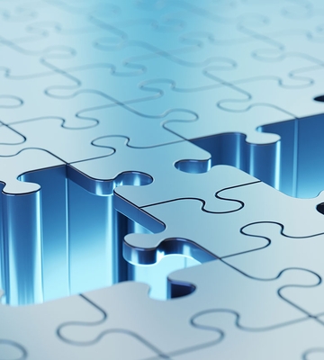 Eine Nahaufnahme eines leuchtend blauen Puzzles, bei dem ein Teil über seinen Platz hinausragt, wodurch die Lücke und die ineinander greifenden Kanten der Puzzleteile hervorgehoben werden.